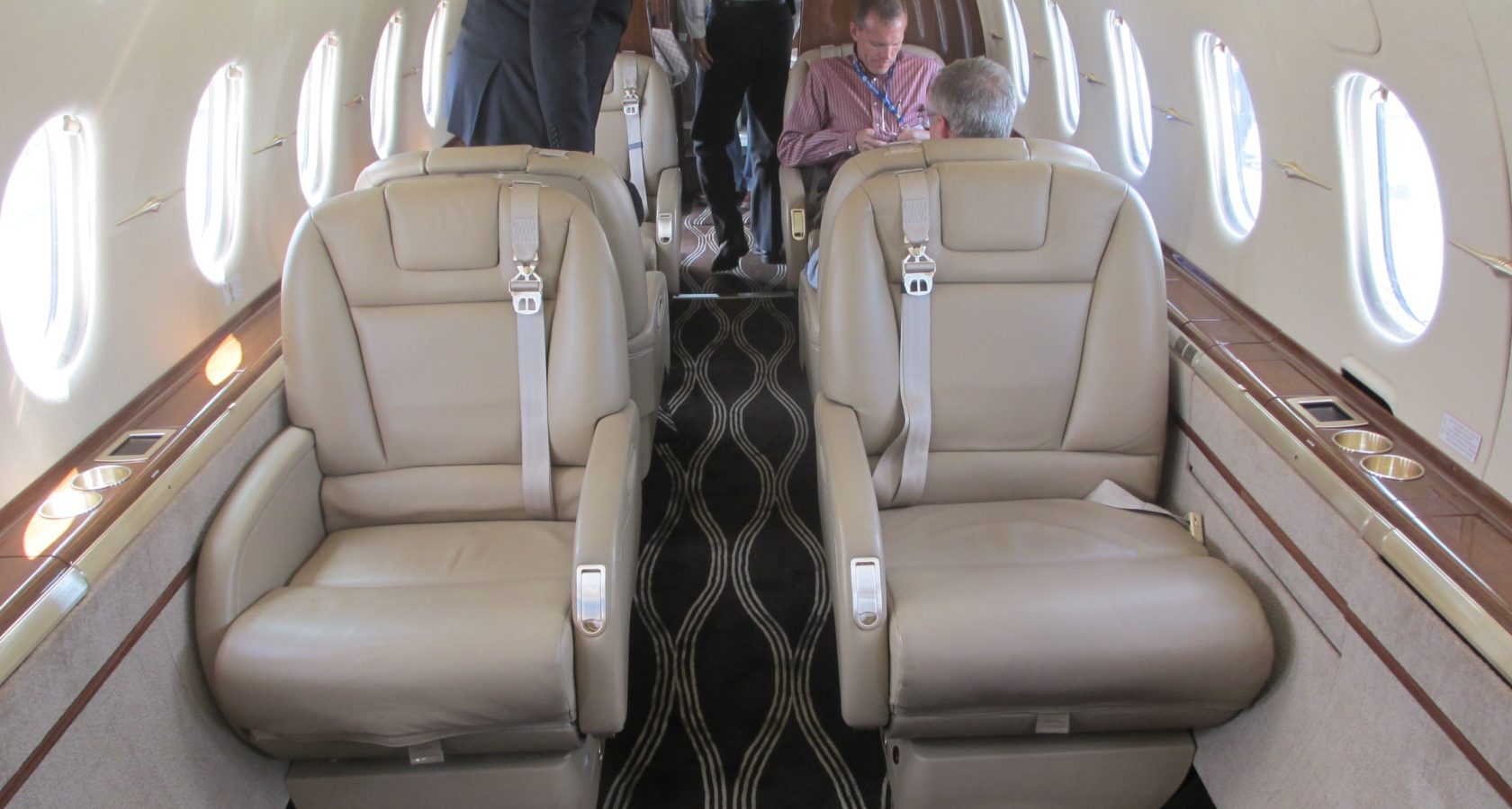 Interior cabin of a private business jet with leather club seating