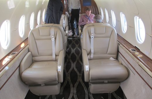 Interior cabin of a private business jet with leather club seating